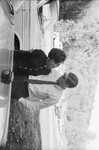 Couple Hugging Next to a Car